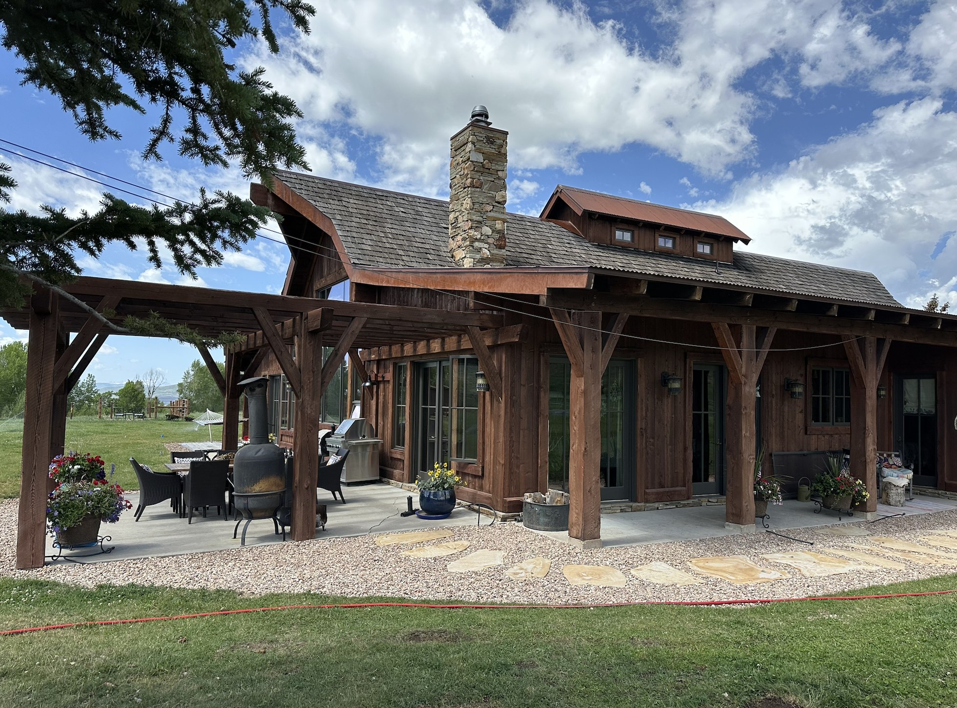 Rustic cabin with custom stone patio and gravel landscaping
